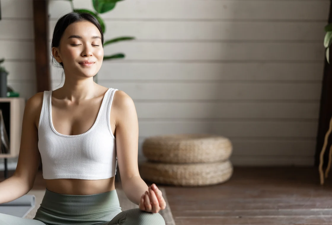 woman meditating looking calm and happy